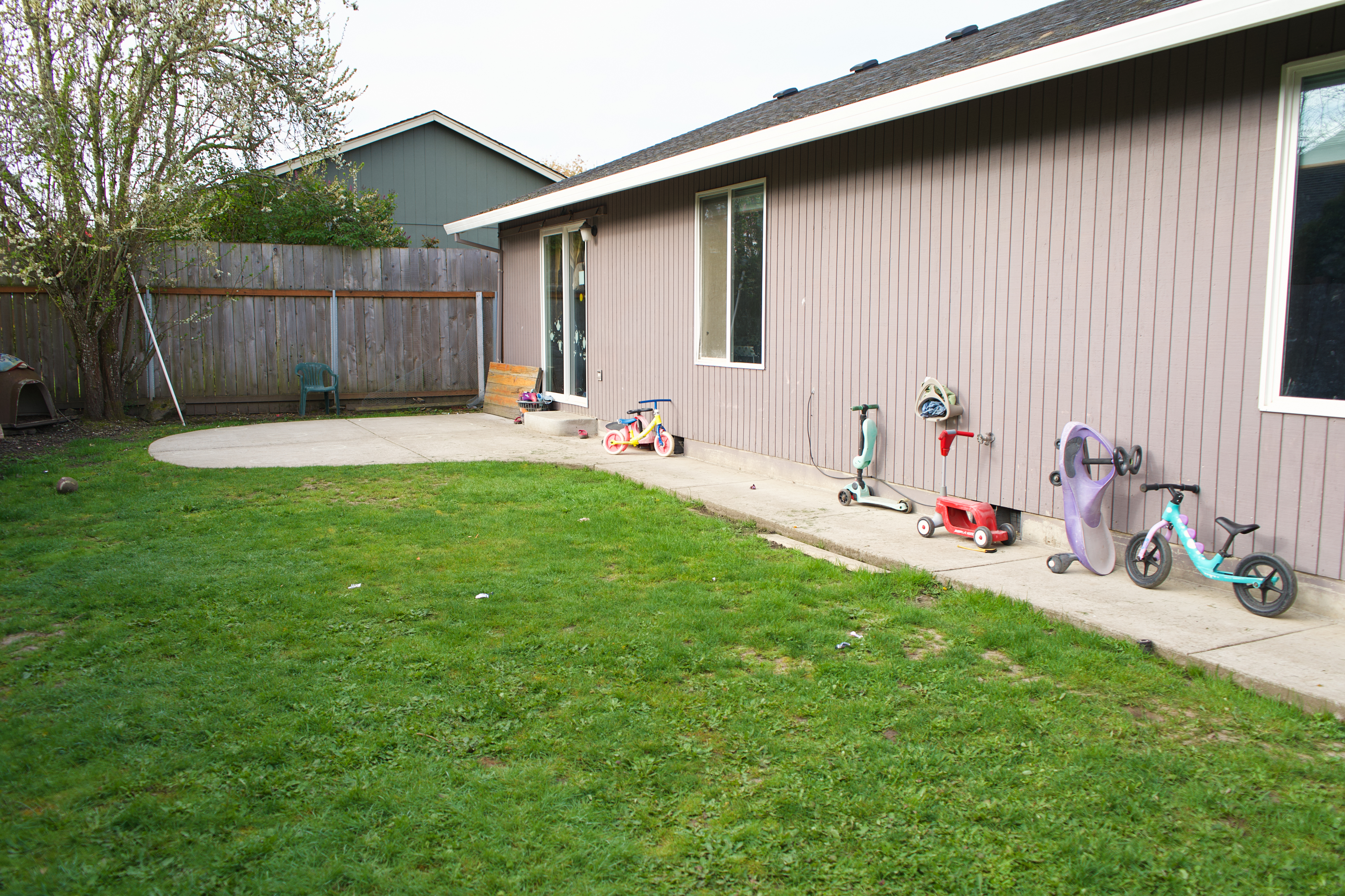 Outdoor play space with climbing, scooters, and nature exploration.